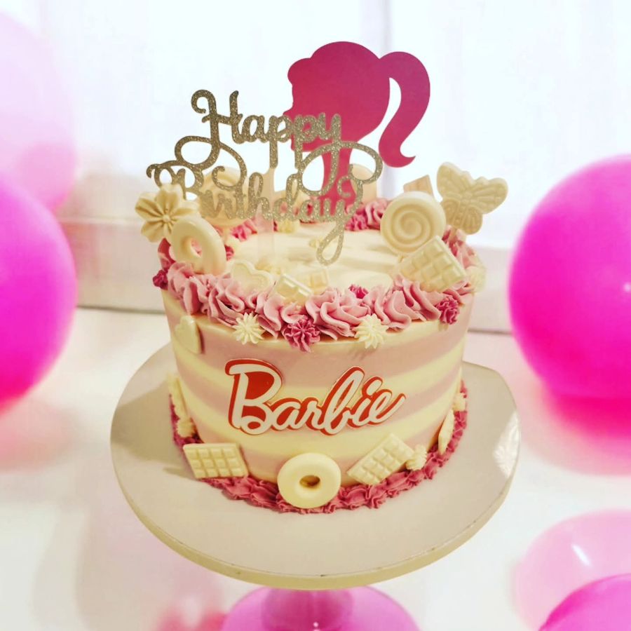 Pink striped Barbie birthday cake with white chocolate decorations