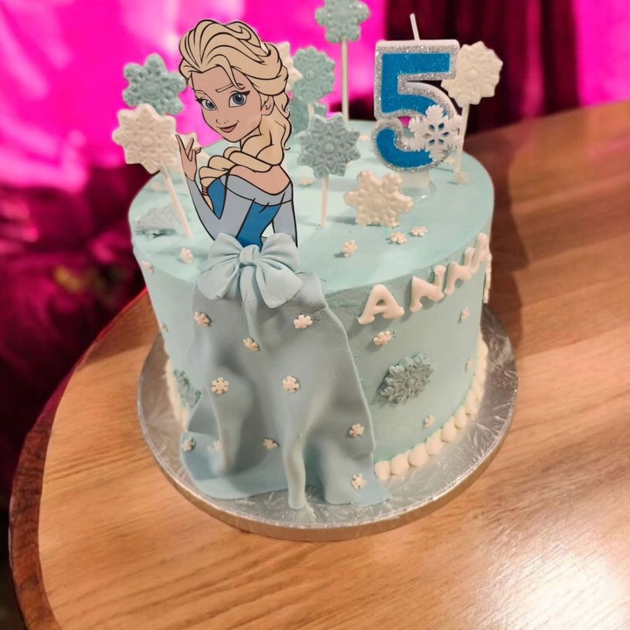 Light blue Elsa cake with a fondant gown and snowflakes for a 5th birthday
