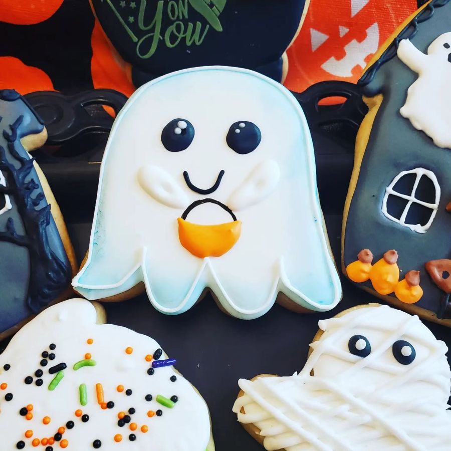 Halloween sugar cookies with a trick-or-treat ghost, mummy and haunted house