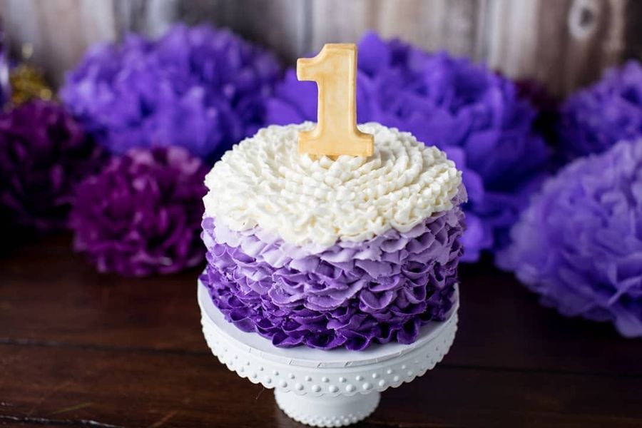 Purple ombre ruffle first birthday smash cake with a gold number 1